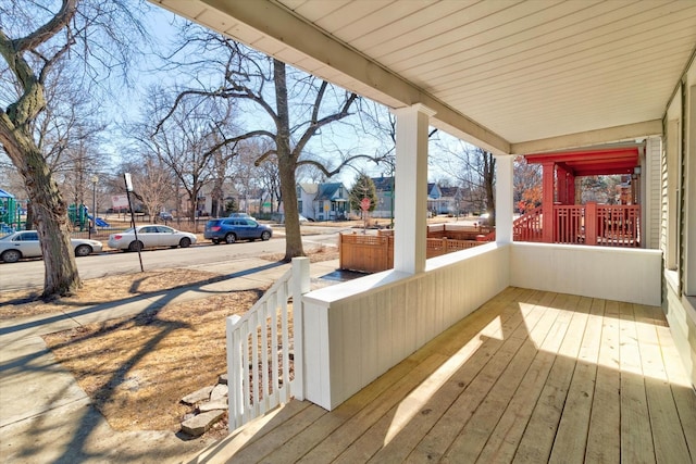 wooden terrace with covered porch and a residential view