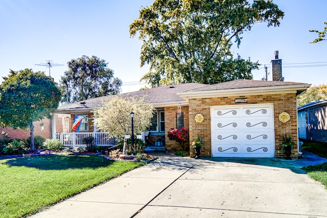 ranch-style home featuring covered porch, a front yard, and a garage