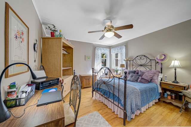 bedroom with crown molding, light wood-type flooring, and ceiling fan