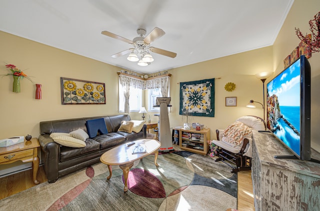 living room featuring light hardwood / wood-style flooring and ceiling fan