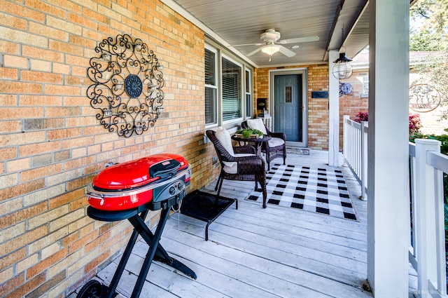 wooden deck with covered porch and ceiling fan