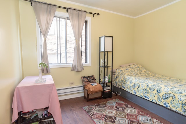 bedroom with dark wood-type flooring, ornamental molding, and a baseboard radiator