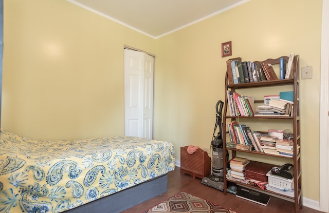 bedroom with ornamental molding and dark hardwood / wood-style flooring