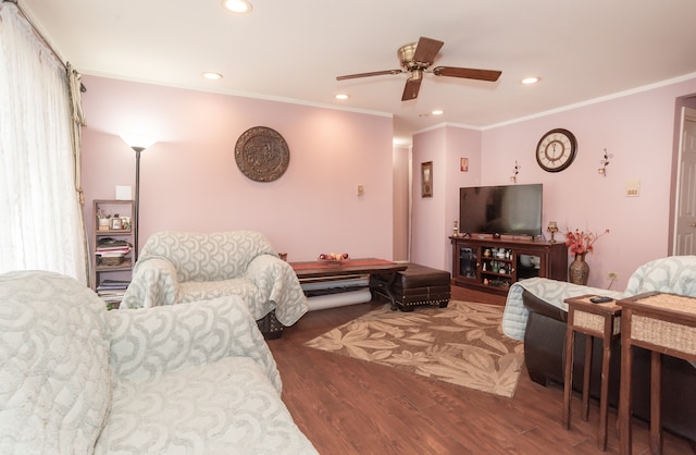 living room featuring ceiling fan, ornamental molding, and dark hardwood / wood-style flooring