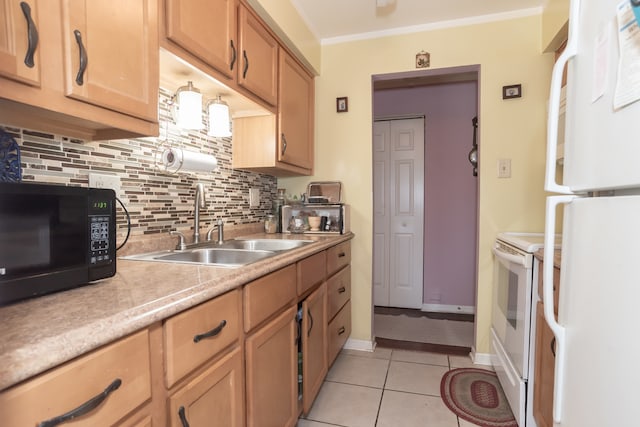 kitchen with decorative backsplash, sink, light tile patterned floors, and white appliances