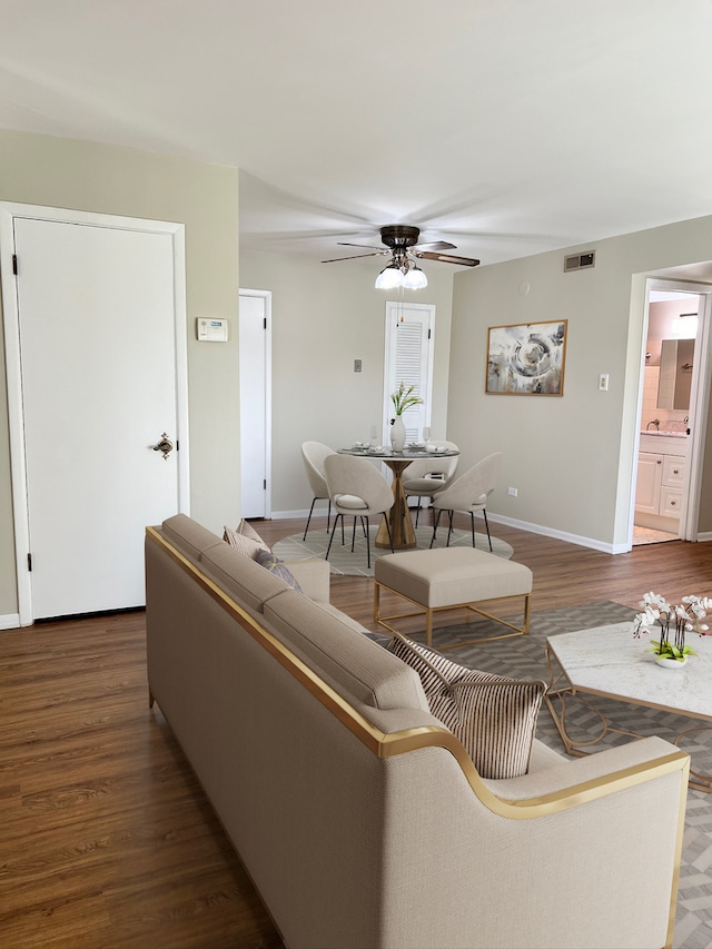 living room featuring dark hardwood / wood-style flooring and ceiling fan