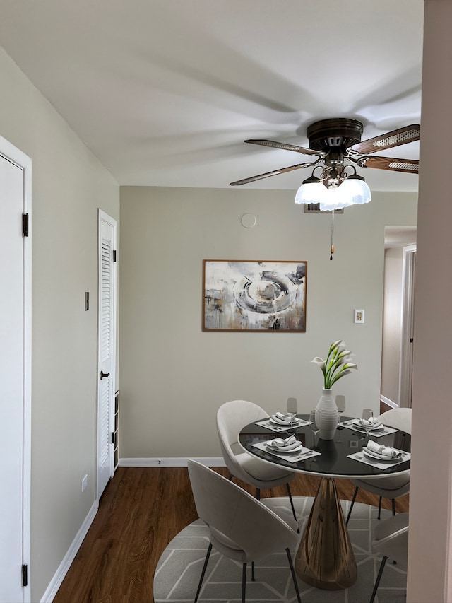 dining area featuring dark hardwood / wood-style floors and ceiling fan