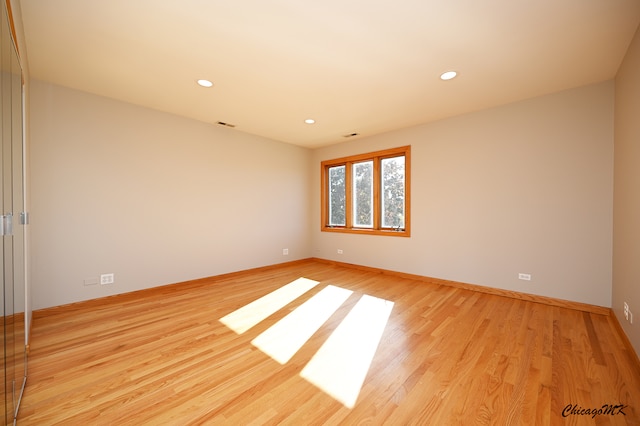 unfurnished room with light wood-type flooring