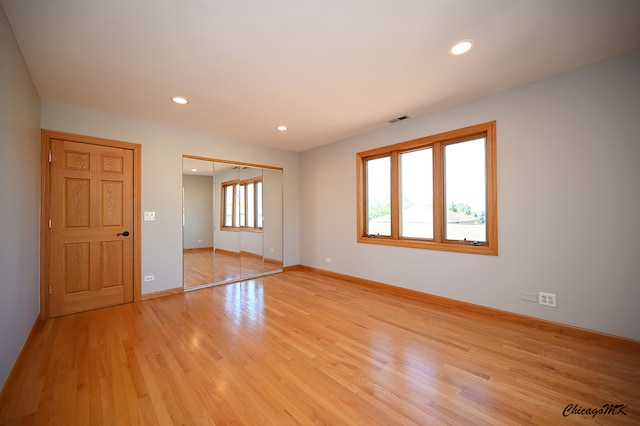 unfurnished room with light hardwood / wood-style flooring