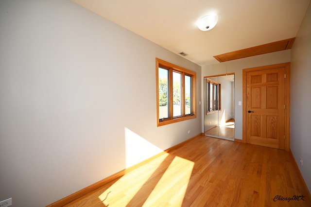 hallway with hardwood / wood-style flooring