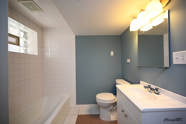 bathroom with vanity, toilet, a bathtub, and tile patterned flooring