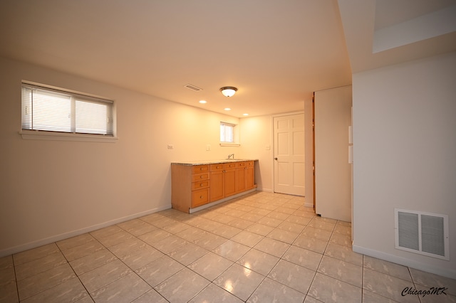 tiled spare room featuring sink