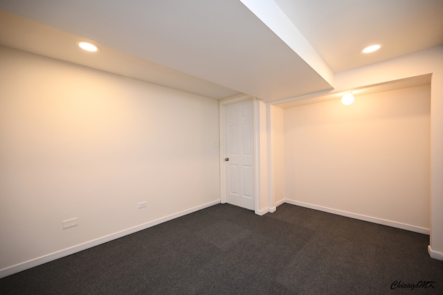 basement featuring dark colored carpet