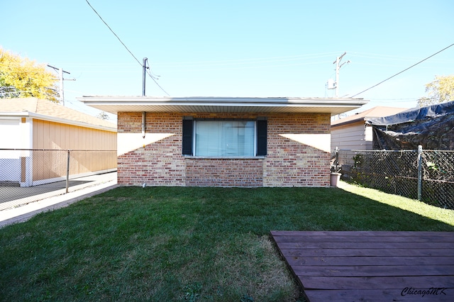 rear view of house featuring a lawn