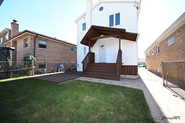 rear view of house with a lawn