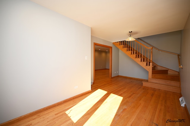 empty room with hardwood / wood-style flooring