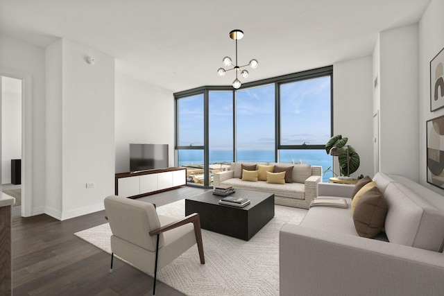 living room featuring hardwood / wood-style flooring, a wall of windows, and a chandelier