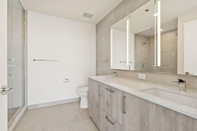 211 N Harbor Dr Unit 3704, Chicago, IL 60601 - bathroom featuring double vanity, a stall shower, and tile patterned floors