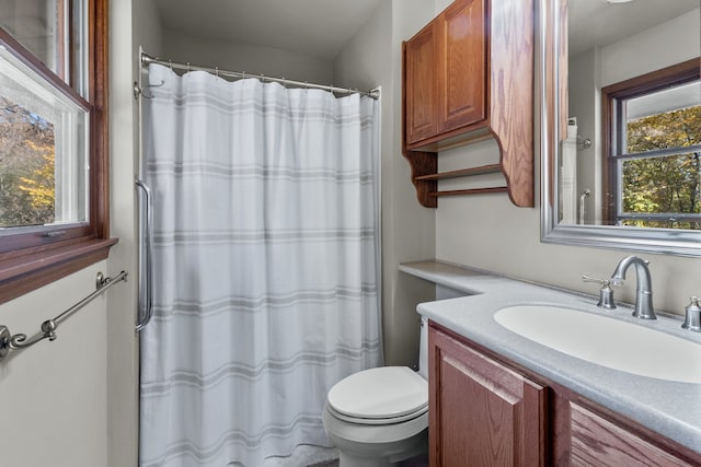 bathroom featuring vanity, toilet, and curtained shower