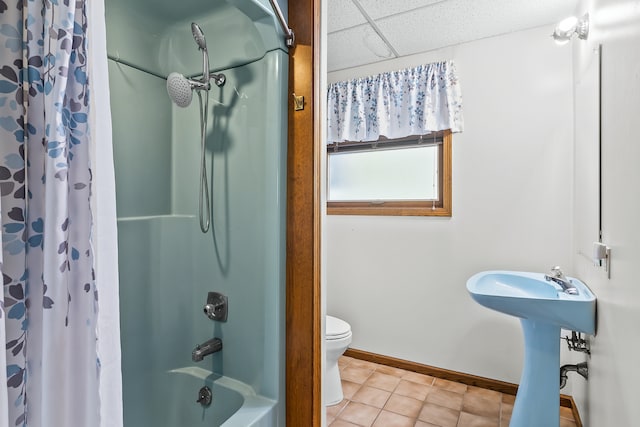 full bathroom with sink, shower / bath combination with curtain, a paneled ceiling, toilet, and tile patterned flooring