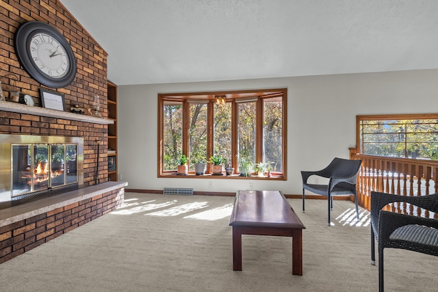 carpeted living room featuring a healthy amount of sunlight, a textured ceiling, lofted ceiling, and a fireplace