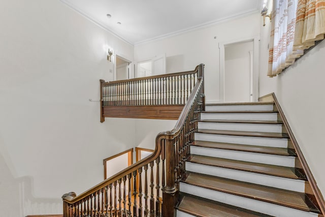 staircase featuring ornamental molding