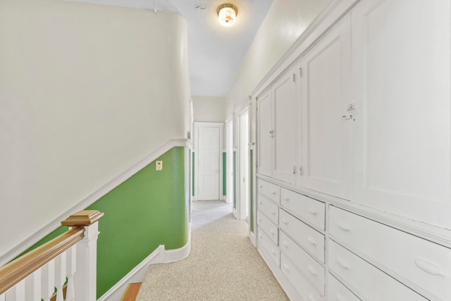 hallway with light colored carpet