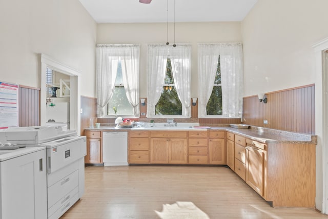 kitchen featuring a wealth of natural light, dishwasher, light hardwood / wood-style flooring, and light brown cabinetry