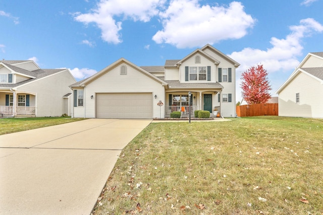 view of front property featuring covered porch, a front yard, and a garage