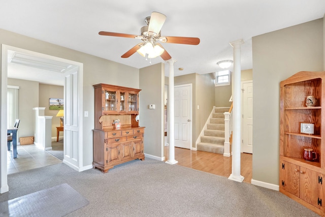 carpeted living room with ceiling fan