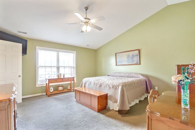 bedroom with ceiling fan, vaulted ceiling, and light colored carpet