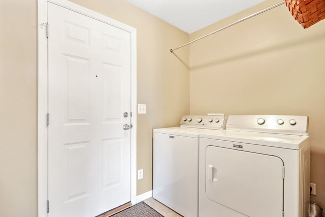 laundry room featuring washer and dryer and a textured ceiling