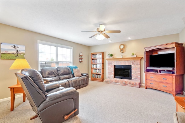 carpeted living room featuring a textured ceiling, a fireplace, and ceiling fan