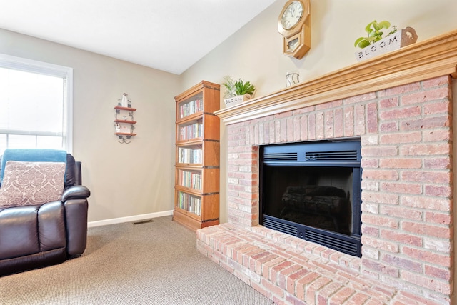 interior space featuring carpet flooring and a fireplace