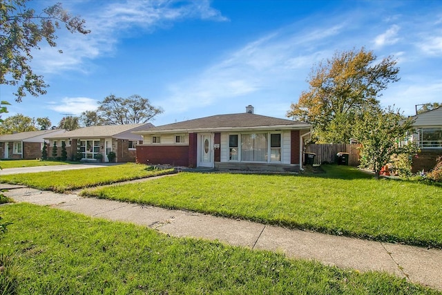 ranch-style home with a front lawn