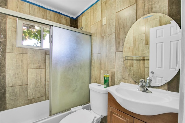 full bathroom with vanity, shower / bath combination with glass door, and toilet