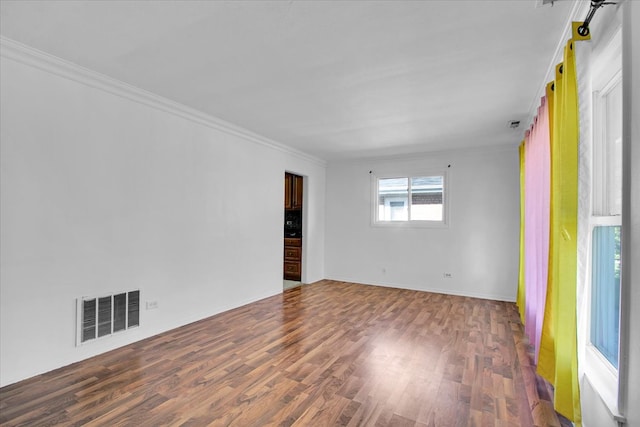 spare room with crown molding and dark hardwood / wood-style flooring