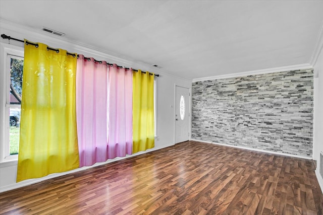 spare room with ornamental molding and dark hardwood / wood-style flooring