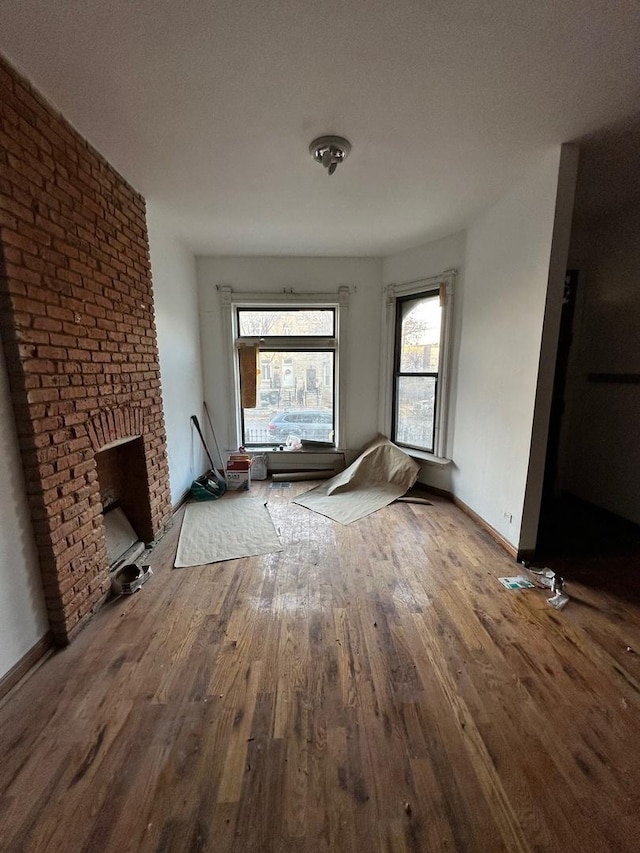 unfurnished living room with a fireplace, hardwood / wood-style floors, and a textured ceiling