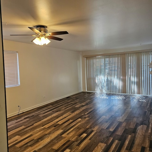 empty room featuring dark wood-type flooring and ceiling fan