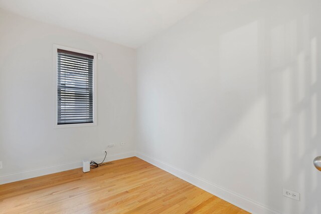6832 S Cornell Ave Unit 1, Chicago, IL 60649 - empty room with baseboards and light wood finished floors
