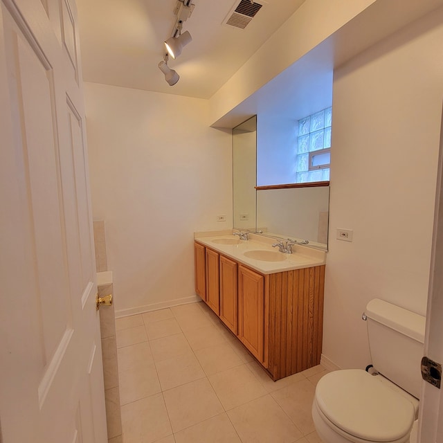 bathroom featuring vanity, track lighting, toilet, and tile patterned floors