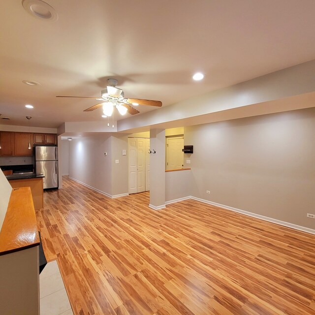 unfurnished living room with light hardwood / wood-style floors and ceiling fan