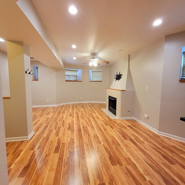 basement featuring ceiling fan and light wood-type flooring