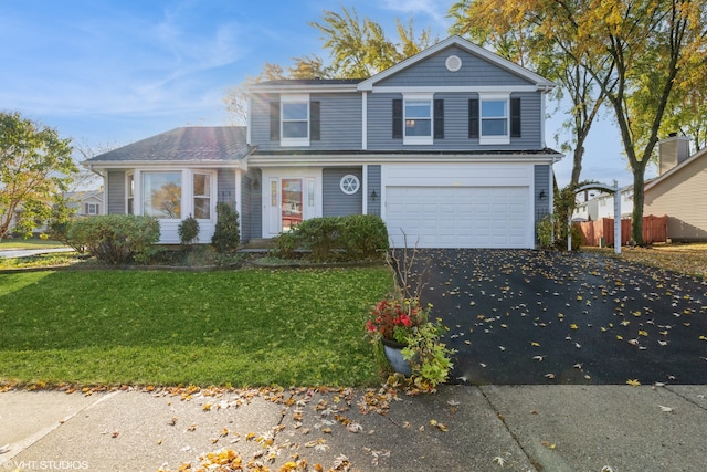 front of property featuring a front lawn and a garage