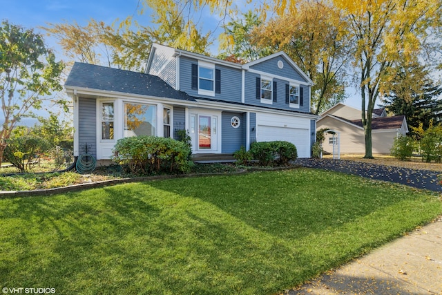 view of front property featuring a front lawn and a garage