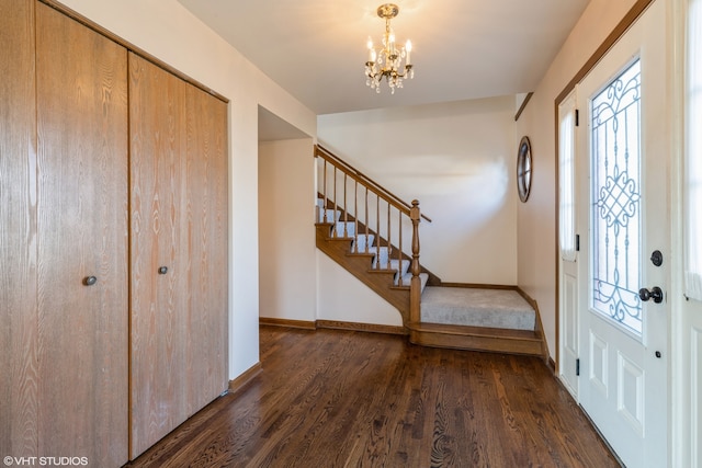 entrance foyer with a notable chandelier and dark hardwood / wood-style flooring