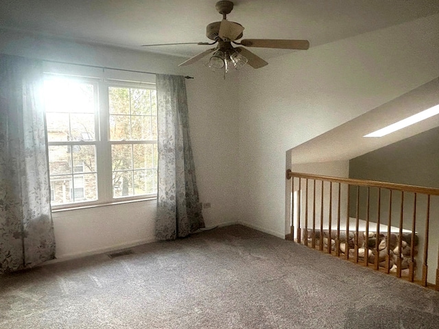 empty room featuring carpet floors and ceiling fan