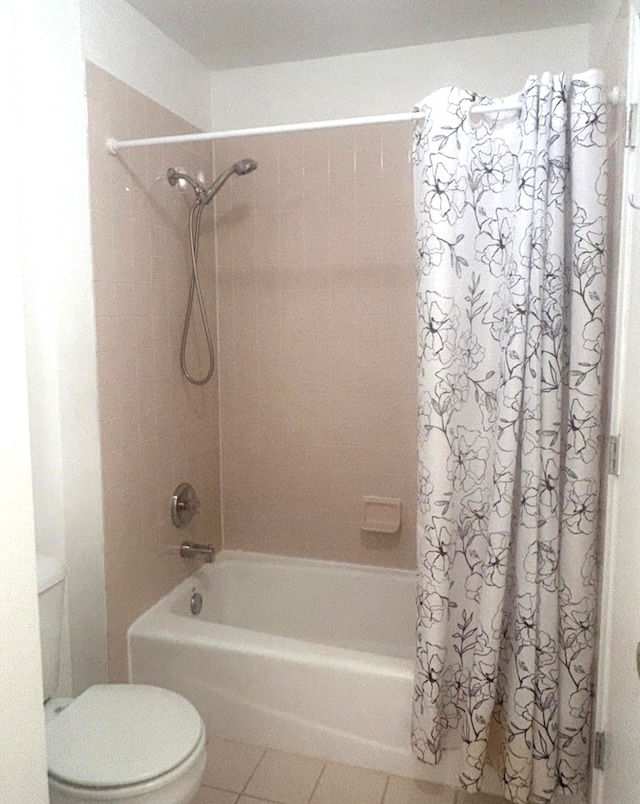 bathroom featuring shower / bath combo, toilet, and tile patterned flooring