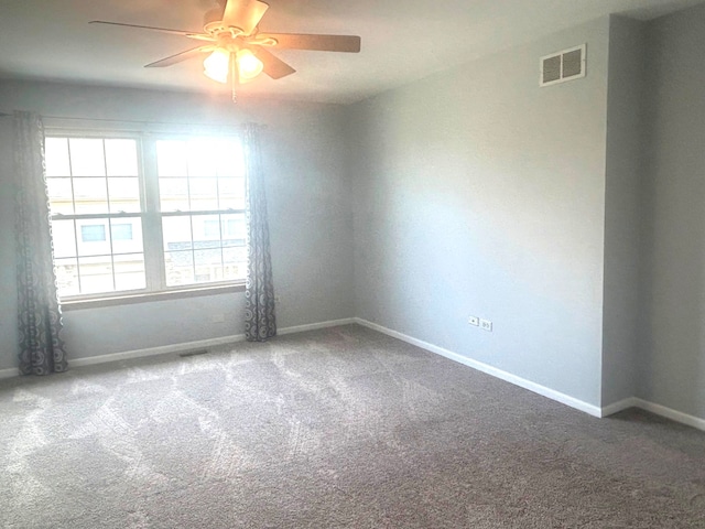 carpeted empty room featuring ceiling fan